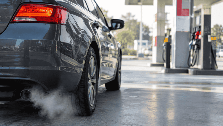 Car engine idling while parked with the dashboard fuel gauge visible